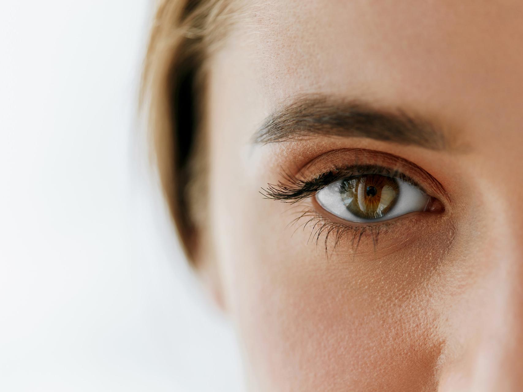 The image shows a close-up of a woman’s face, focussing on the left eye. 