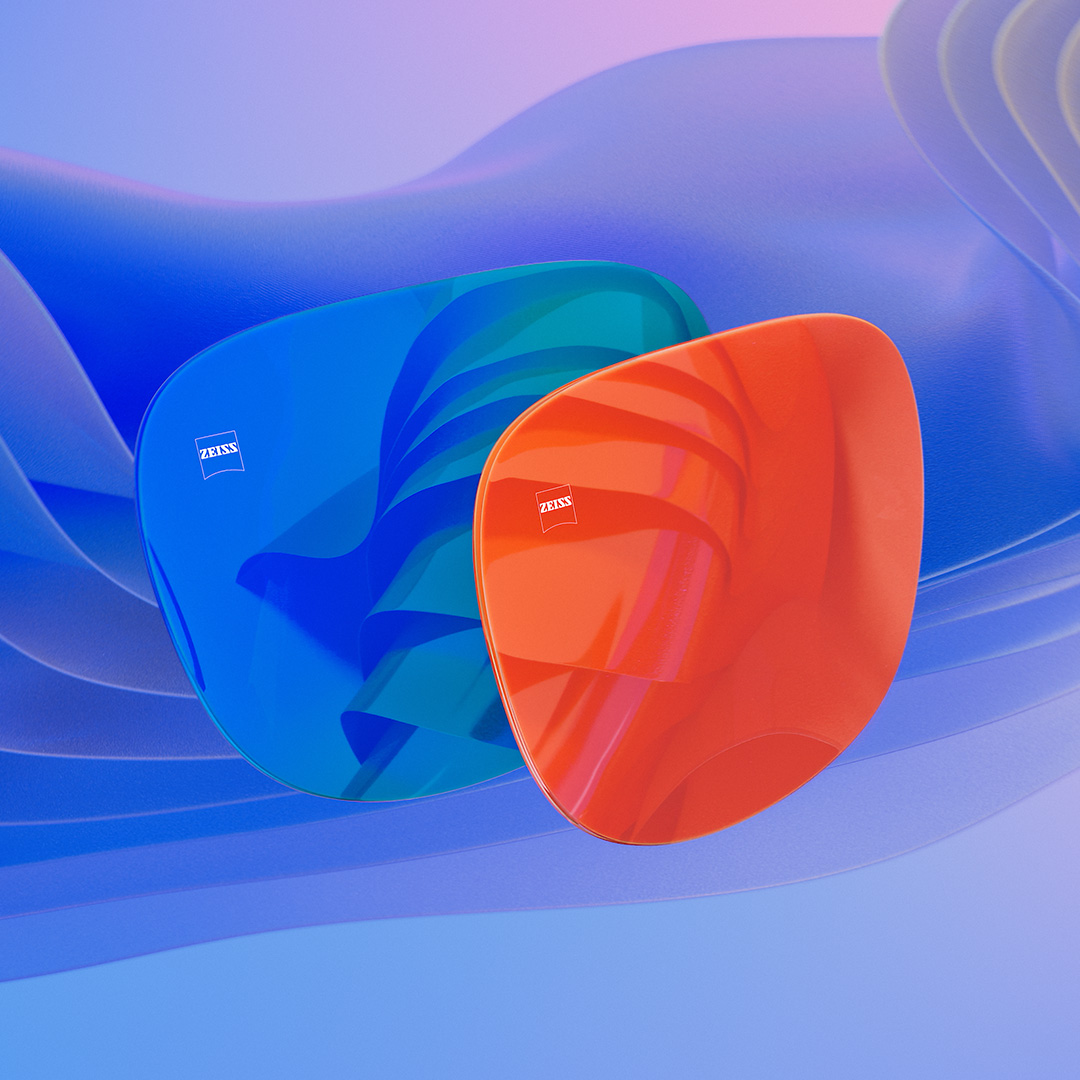 Ilustração 3D gerada por computador de duas lentes de óculos de sol com revestimento espelhado azul e laranja.