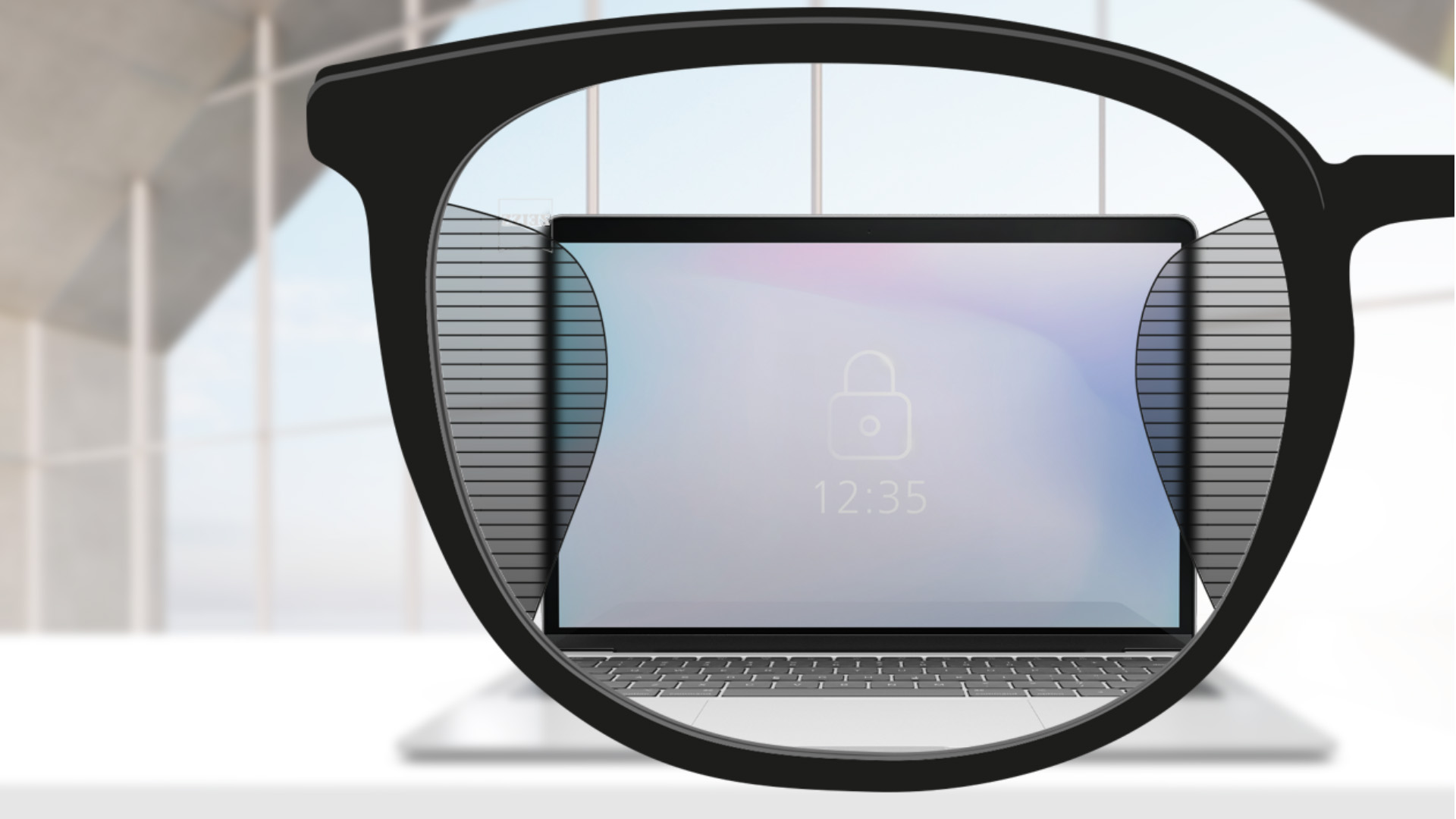 Imagem através da lente ZEISS Office de um ecrã de computador ao centro e finas parcelas desfocadas à esquerda e à direita.