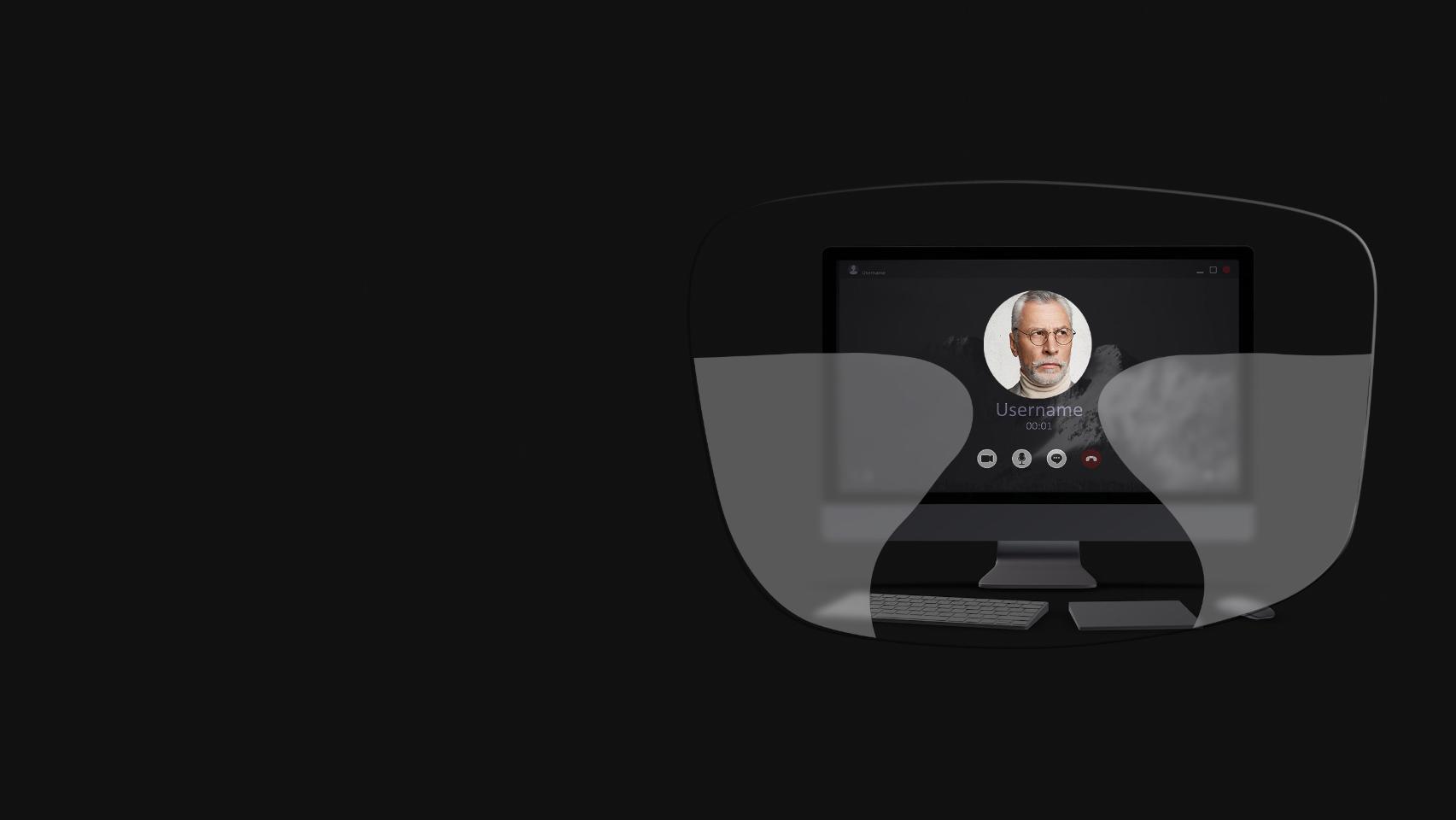 A vista de um computador de secretária, de um teclado, de um rato e de um livro através de uma ilustração esquemática de uns óculos progressivos mostra que as zonas de visão de perto e intermédia são demasiado pequenas para uma visão nítida do ecrã.