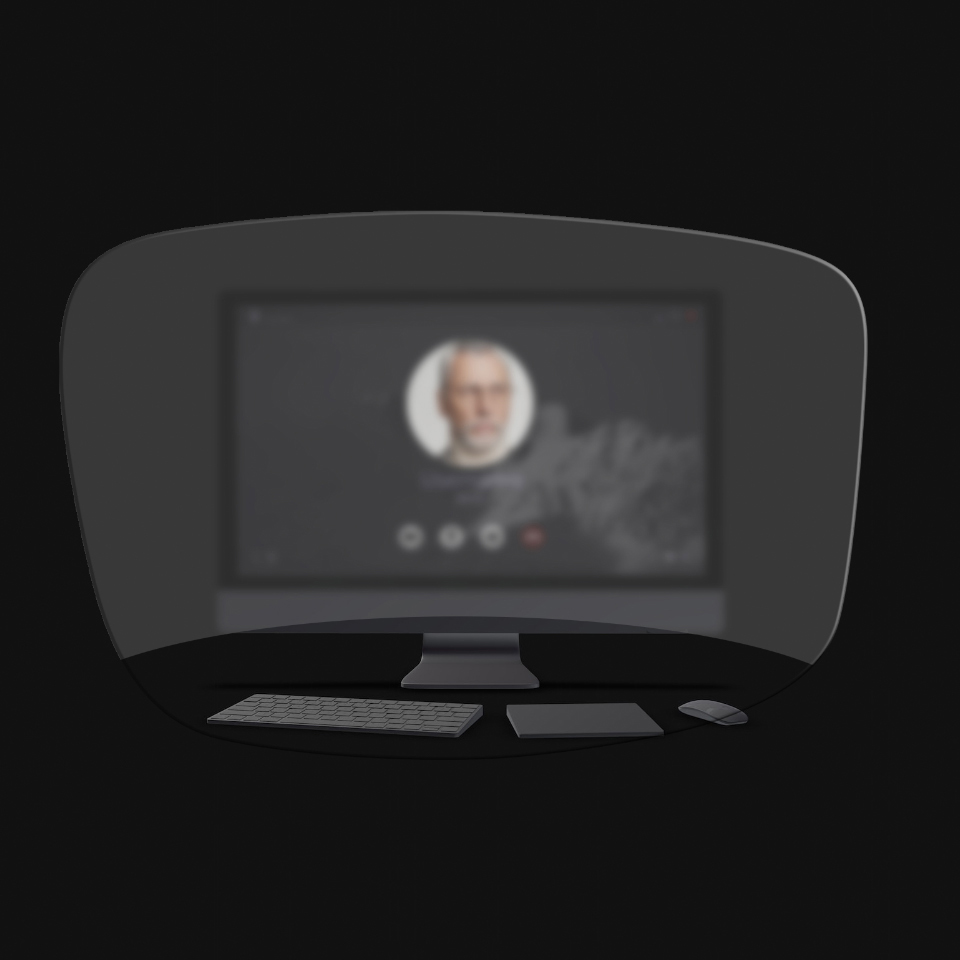 A vista de um computador de secretária, de um teclado, de um rato e de um livro através de uma ilustração esquemática de uns óculos de leitura mostra que apenas os objetos muito próximos são claramente visíveis. O ecrã do computador está desfocado.