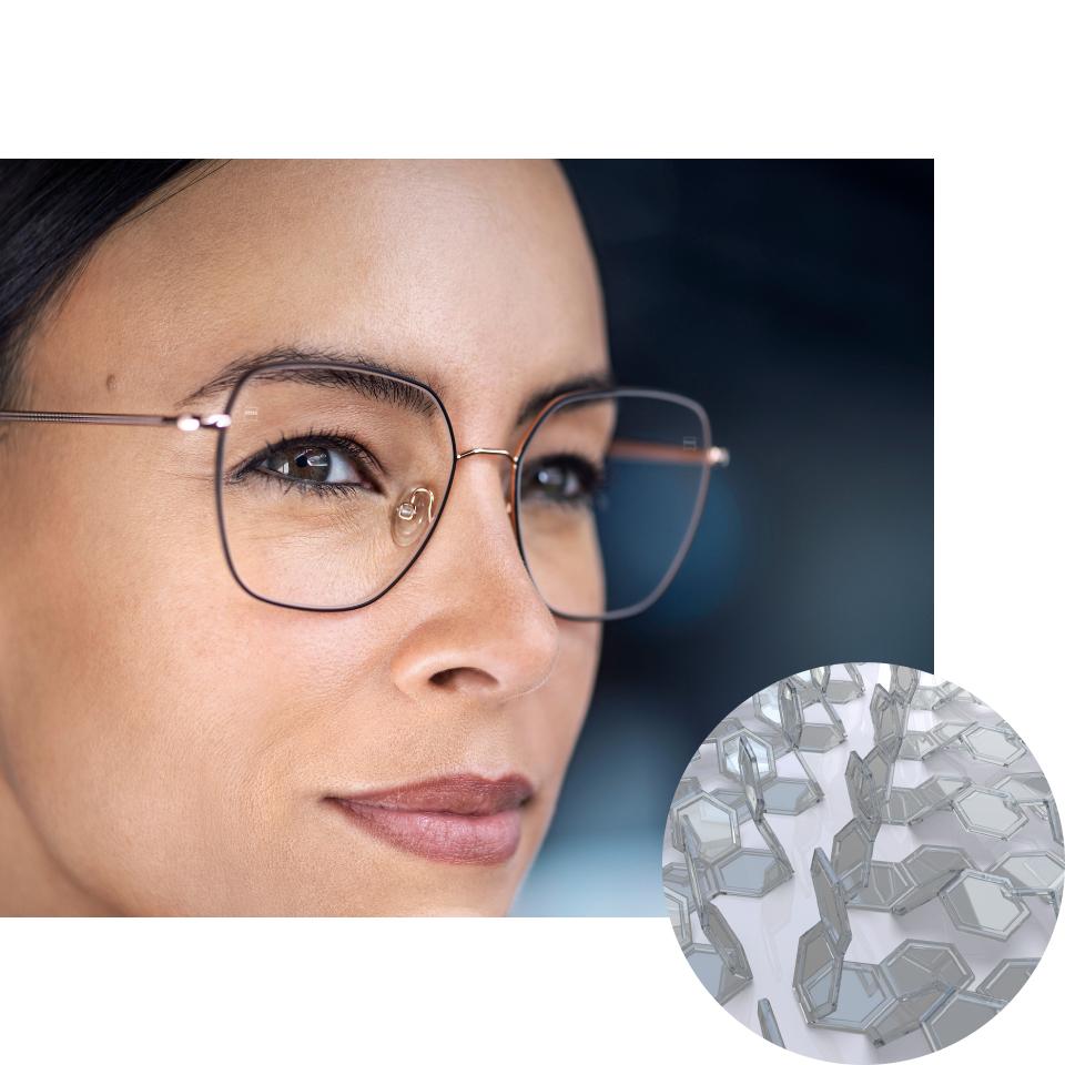 Mulher a usar óculos com ZEISS PhotoFusion X no modo incolor, com uma imagem dos compostos de corantes dobrados. 