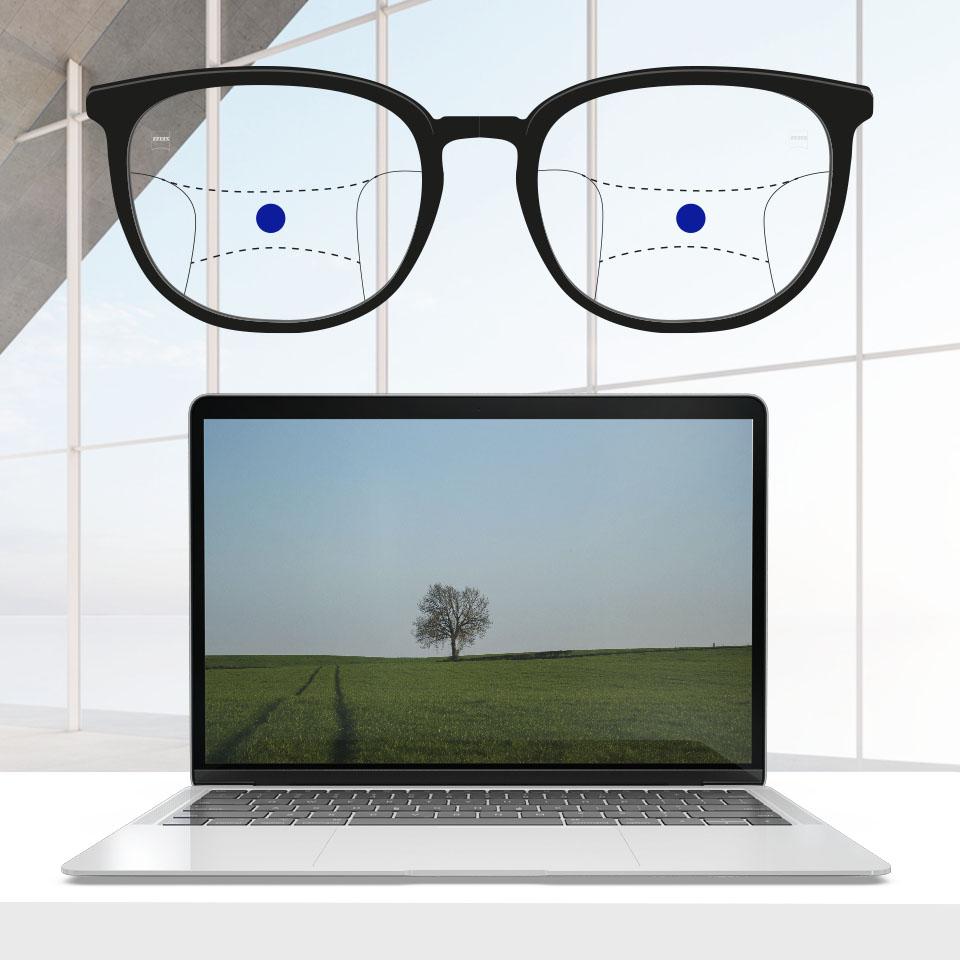 Uma armação com lentes progressivas e linhas esquemáticas que indicam as diferentes zonas de visão. As diferentes partes da lente estão assinaladas: visão no intermédio - parte central da lentes.